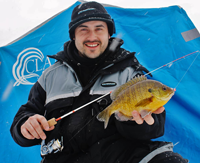 image of Blake Liend holding Bluegill on ice