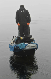 image of ice fisherman on wet ice