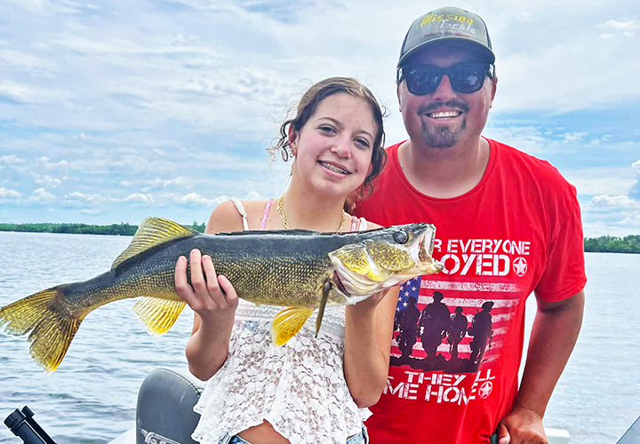 image of Justin Chromy of the Patriot Guide Service on Lake Vermilion with female customer