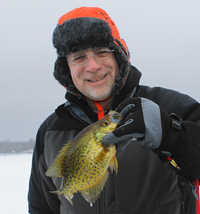 image of ice fisherman holding big crappie