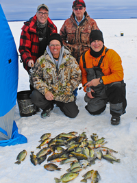 image of ice fishing party with fish on ice