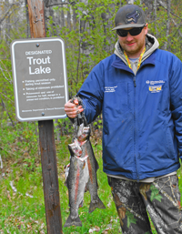 image of Jesse Clusiau with 2 rainbow trout