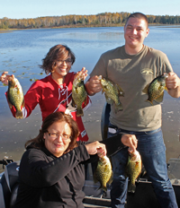 image of family all holding crappies